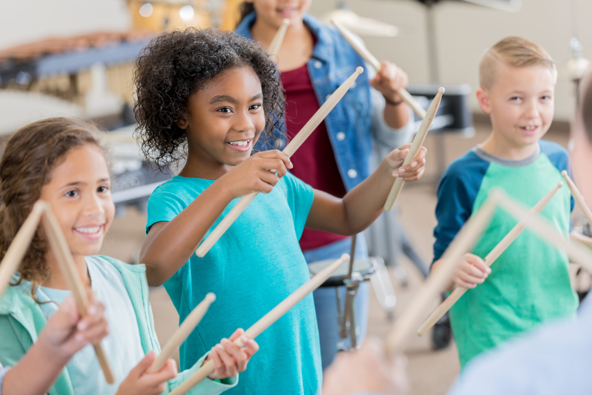 Elementary students learn to play percussion instruments Little